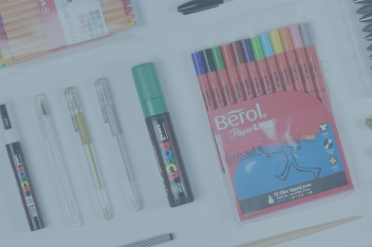 Flat lay of signo pens, posca pens and berol pens